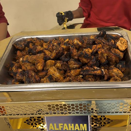 Alfaham chicken in a gold chafing dish with its counter label