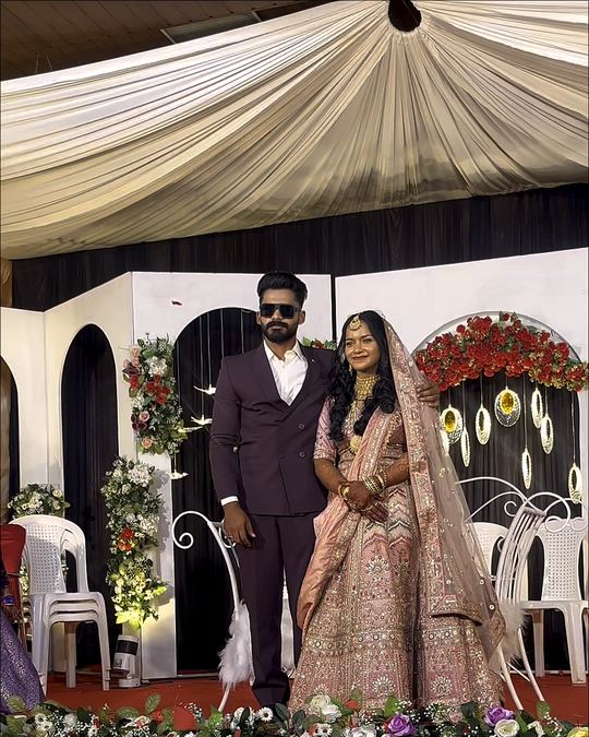 Bride and groom on a floral wedding stage