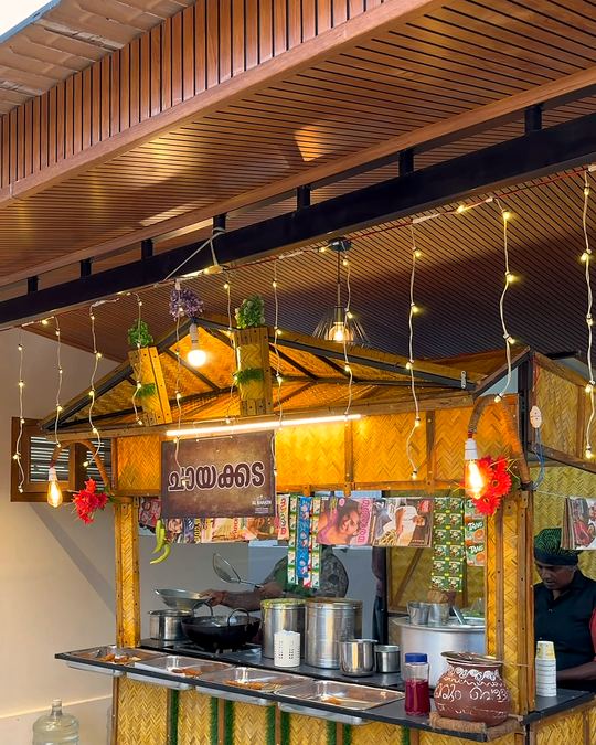 Wooden live tea stall glowing with warm string lights