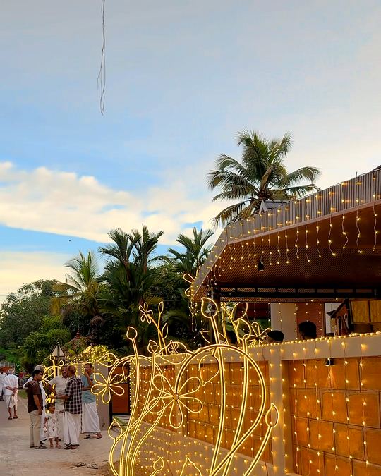 Home venue at dusk with a gold light sculpture along the entrance