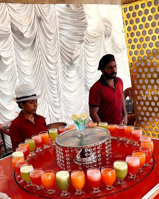 Welcome drinks station with a circle of coloured mocktails